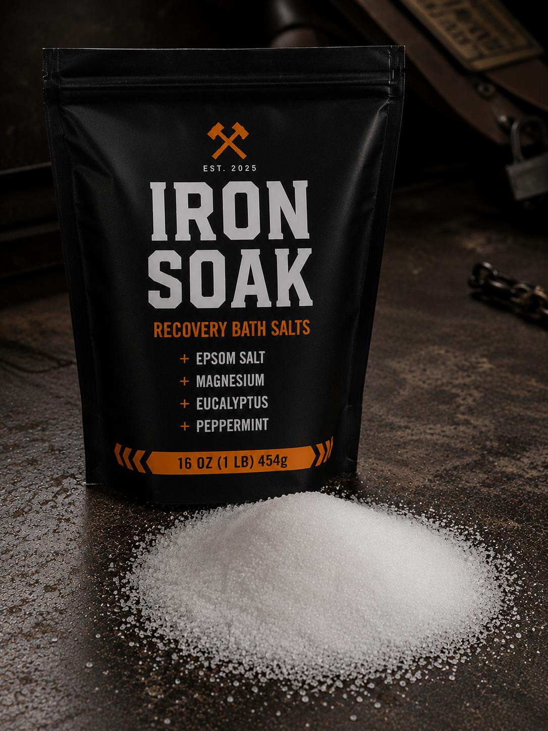 Iron Soak Recovery Bath Salts bag with salts poured out on dark industrial surface.